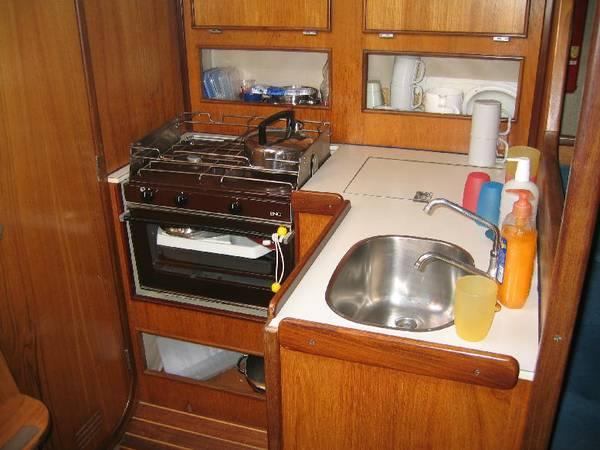The galley with a cooker, fridge (off) and a small sink.