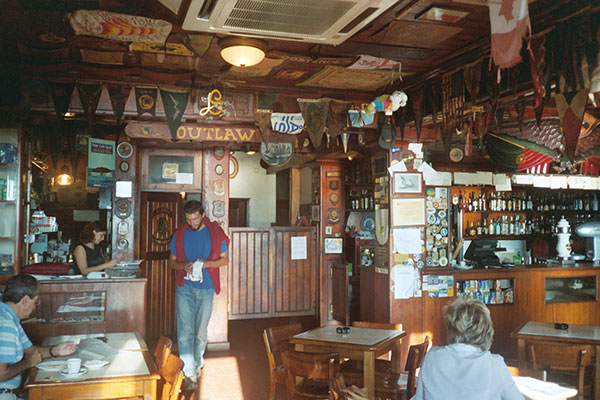 Lukasz in Peter's Sport Bar, Horta, Azores. Our original Canadian Flag hanging from the ceiling.